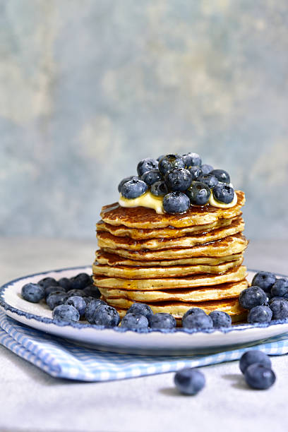 istock Stack of fresh hot banana pancakes with maple syrup and blueberries for a breakfast. 2232266965