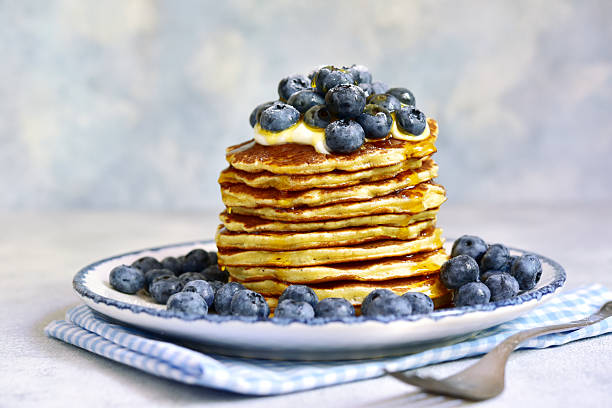 istock Stack of fresh hot banana pancakes with maple syrup and blueberries for a breakfast. 2232266977