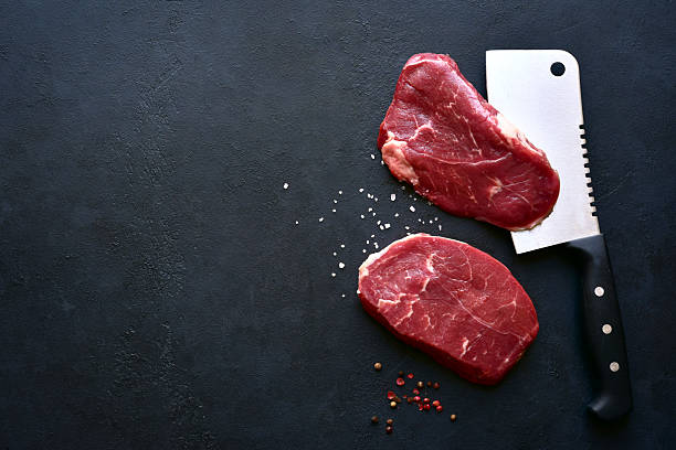 istock Raw organic marbled beef steaks with ingredients for cooking . Top view with copy space. 2232267178