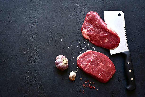 istock Raw organic marbled beef steaks with ingredients for cooking . Top view with copy space. 2232267184