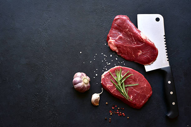 istock Raw organic marbled beef steaks with ingredients for cooking . Top view with copy space. 2232267185