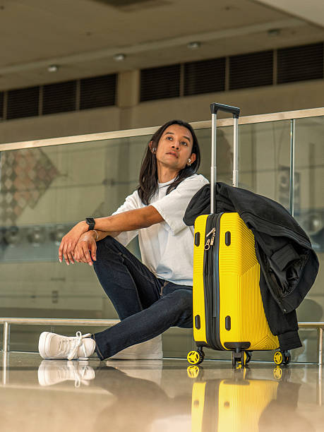 istock Asian passenger with yellow suitcase at airport 2232270791
