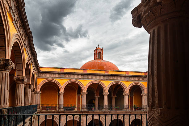 Courtyard with central dome, arched galleries and carved columns in former monastery in Queretaro, Mexico