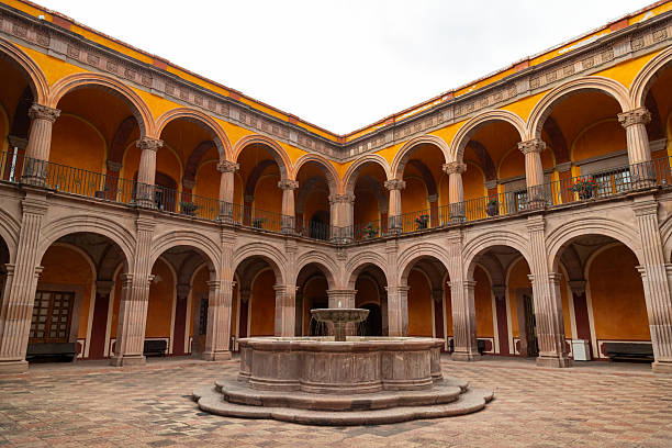 istock Colonial courtyard with central fountain and arched galleries in former monastery in Queretaro, Mexico 2232273638