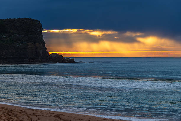 istock Winter sunrise by the sea shore with rain clouds 2232274931
