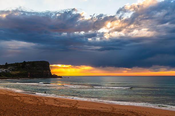 istock Winter sunrise by the sea shore with rain clouds 2232274962