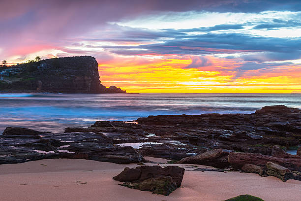 istock Winter sunrise by the sea shore with rain clouds 2232274981