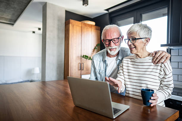 istock Happy senior couple using laptop at home 2232275557