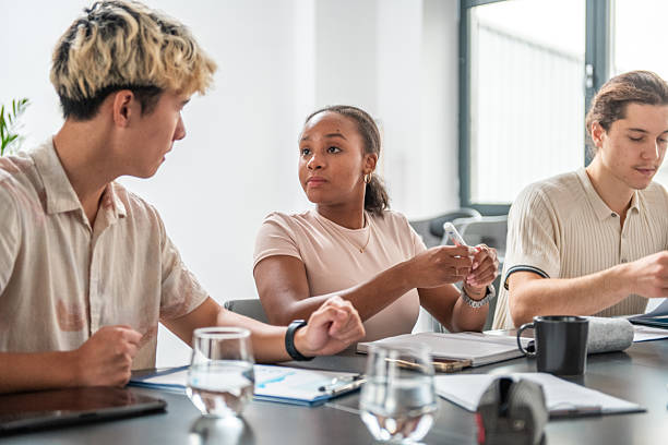 istock Diverse Group of Young Professionals in a Modern Office Discussion 2232276970