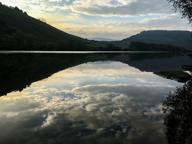 Scenic view on river Mosel by sunset reflecting mountains and sky. Spectacular landscape photo of nature and it's reflection in calm water.