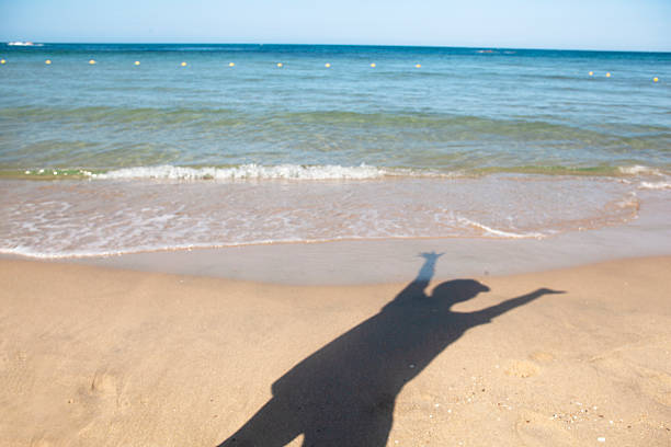 Shadows Reaching Freely on the Beach