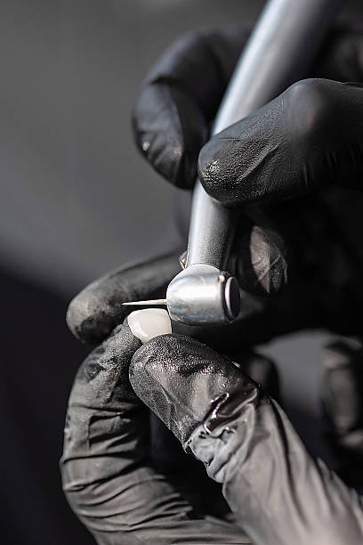 istock Dental technician polishing ceramic crown with rotary tool 2232289647