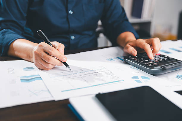 istock Office businesswoman hand to operate calculator analyzing financial data, counting costs on desk. accounting, financial analysis for business budget planning, calculation support, finance management. 2232294338