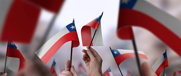 istock Chile flags in their hands on a blurred urban background 2232294520