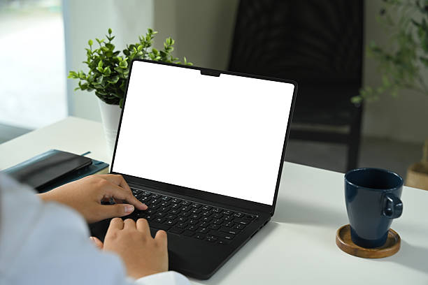 istock Close up of hands typing on laptop with blank screen, for mockup or design presentation 2232294708
