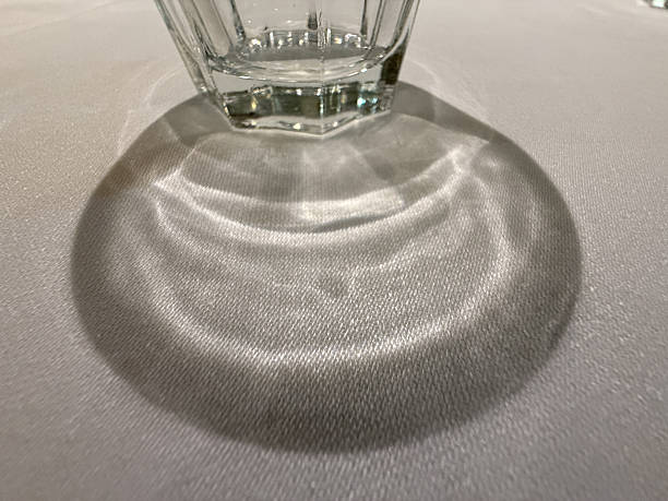 istock A glass is sitting on a table and its shadow is cast on the table 2232300262