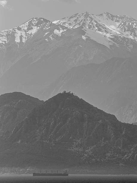 shipping vessel against mountain backdrop