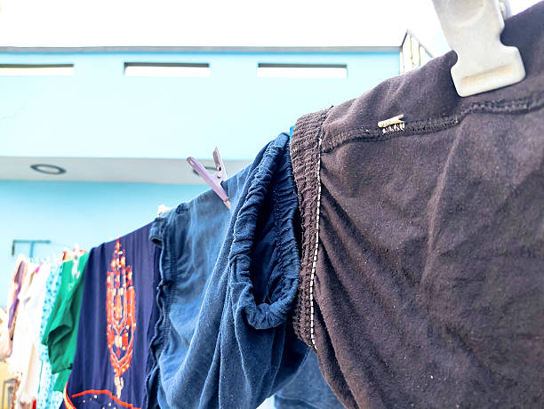 istock Clothes Drying on a Rope Against Blue Wall Outdoors 2232300312