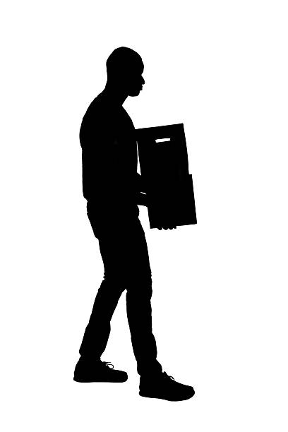 istock silhouette of  side view of walking man carrying cardboard box on white background 2232302317