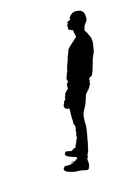 istock silhouette of  side view of a man standing on white background 2232302358