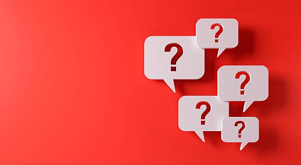 istock Question mark speech bubbles in front of a red wall 2232311437