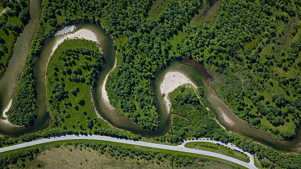 istock Winding River and Remote Beach Surrounded by Forest 2232312369