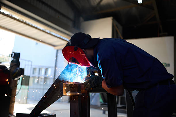 istock Worker welding steel in industrial workshop with sparks and protective gear 2232312415