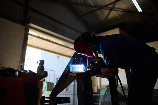 istock Factory worker welding steel in a workshop with safety equipment 2232312451