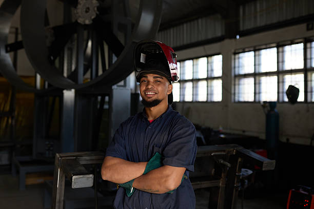 istock Factory worker in protective gear confidently posing near industrial equipment 2232312582