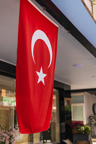 istock A bright red Turkish flag with a white star and crescent hangs outside a building on a sunny day, symbolizing national identity and pride in the community 2232313634