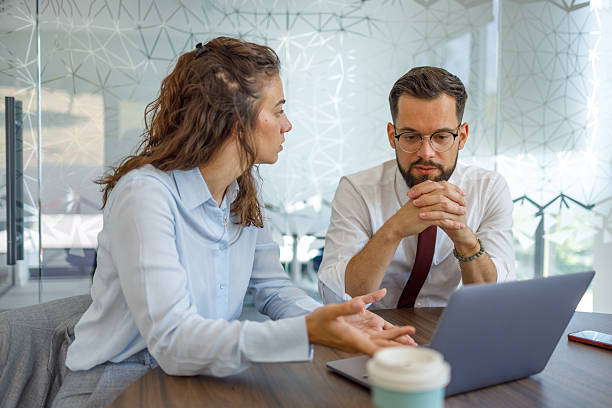 istock Business colleagues discussing work at office desk with laptop 2232315874