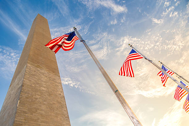istock Washington Monument with American flags in Washington DC, USA 2232316228