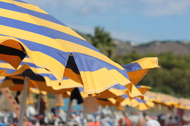 Stripes, blue and yellow parasols on the beach.