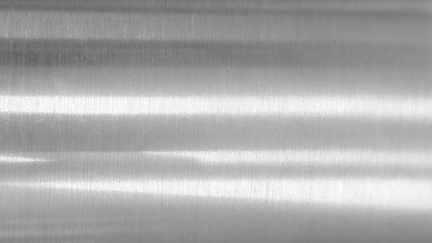 istock Close-up silver or metallic surface with brushed texture. The horizontal grain of the material is visible, creating a pattern of fine, parallel lines. 2232320333