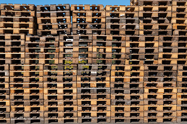 Germany, Berlin, Lichtenberg, August 24, 2025 - Stacked wooden transport pallets