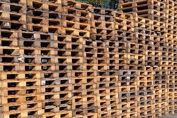 Germany, Berlin, Lichtenberg, August 24, 2025 - Stacked wooden transport pallets