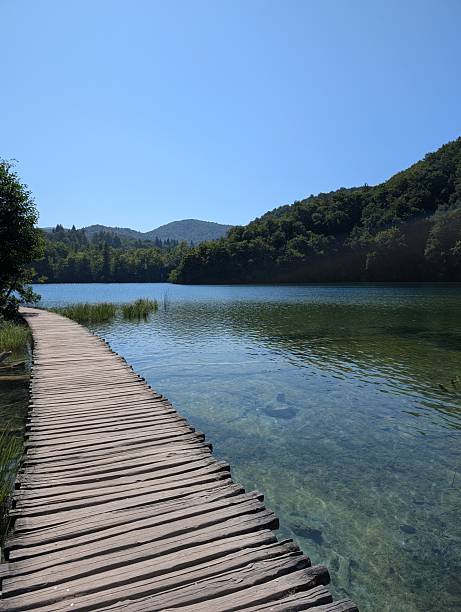 istock Serene boardwalk over clear water in Plitvice Lakes. 2232324567