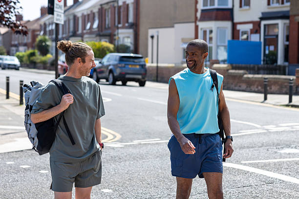 istock Friends Chatting While Walking in a Residential Area 2232324746