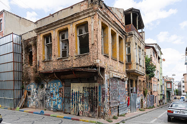 Istanbul, Turkey - August 28, 2025: A derelict two-story building covered with graffiti and broken windows in the Fatih district, reflecting urban decay and neglected architecture.
