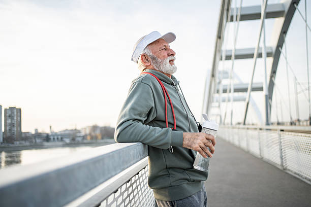 istock Senior man resting after exercising on a bridge 2232325947