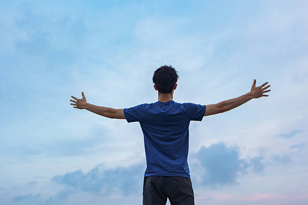 istock A man watching the sunset by the seaside 2232326339