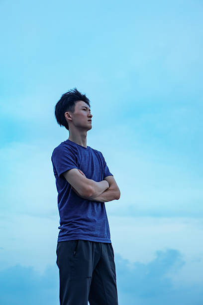 istock A man watching the sunset by the seaside 2232326348
