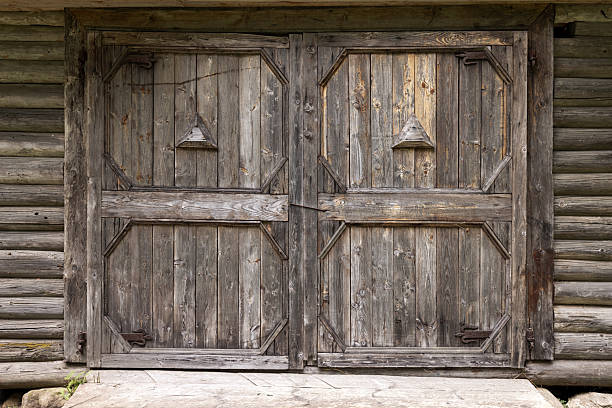 istock Traditional styled weathered wooden double doors, background texture 2232326508