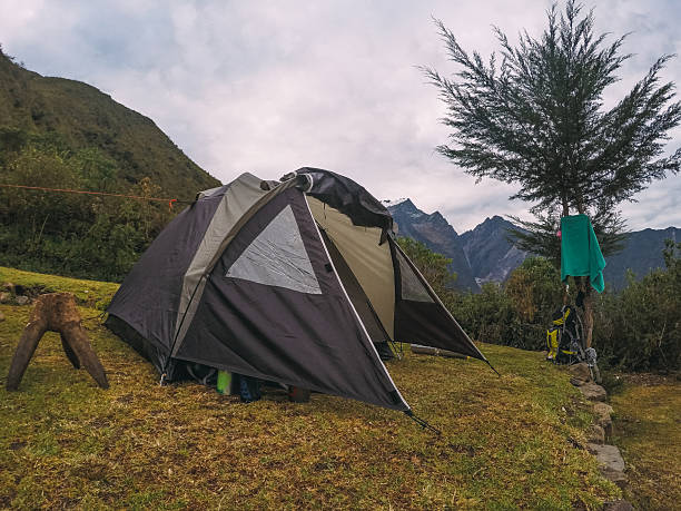 istock Camping tent set up in the andes mountains with backpack and towel 2232327349