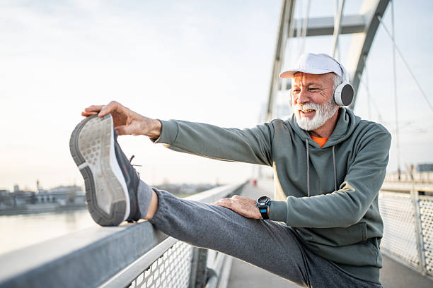 istock Senior man stretching legs after working out outdoors 2232328104