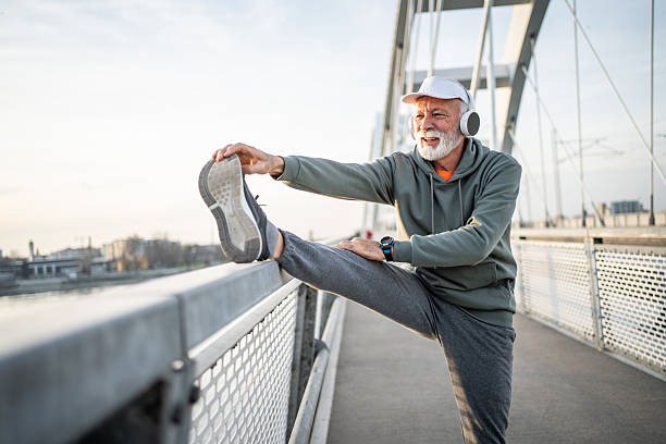 istock Senior man stretching legs after working out on bridge 2232328105