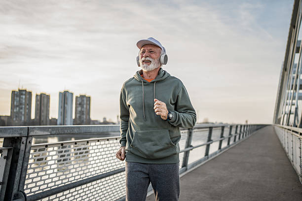 istock Senior man enjoying running on the bridge 2232329096