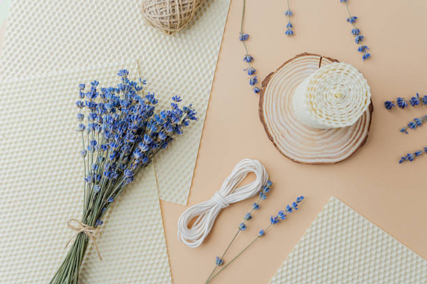 istock Candle making supplies and lavender flowers on beige surface flat lay 2232330089