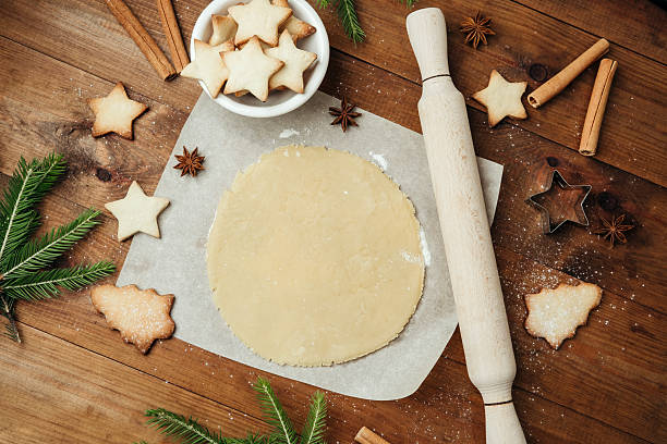istock Festive cookie dough and baking setup on wooden table for christmas culinary and rustic food concept 2232330100