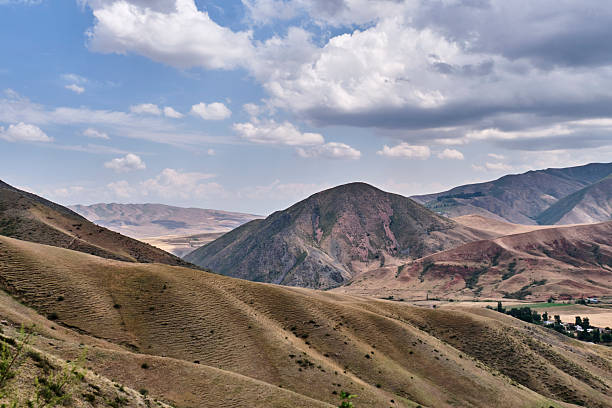 istock Rolling Hills and Mountain Valley Landscape under Cloudy Sky 2232330299